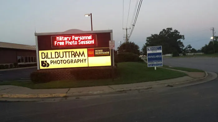 Sign for Billbuttram Photography offers free photo session for military personnel, included in funny names list.