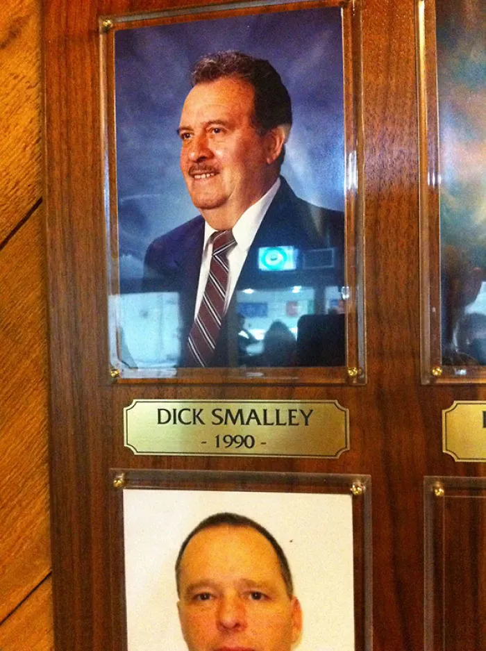 Plaque featuring a funny name, highlighting "Dick Smalley" with a classic portrait from 1990.