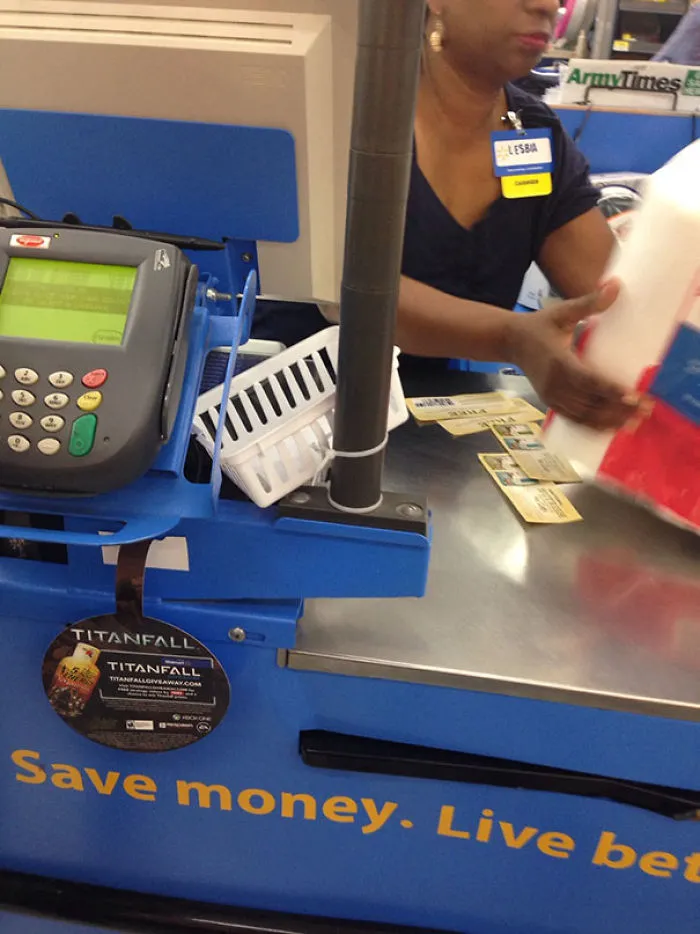 Cashier wearing a name badge with a humorous name at a checkout counter, aligning with funny names theme.
