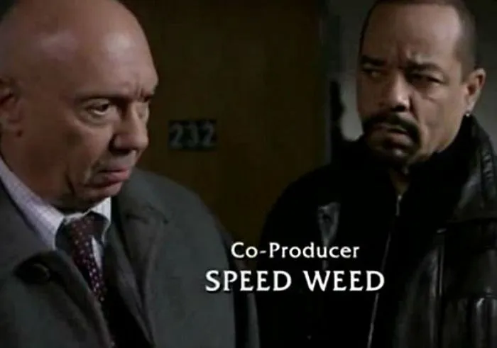 Two serious men in a scene featuring the funny name "Speed Weed" as co-producer credit displayed.