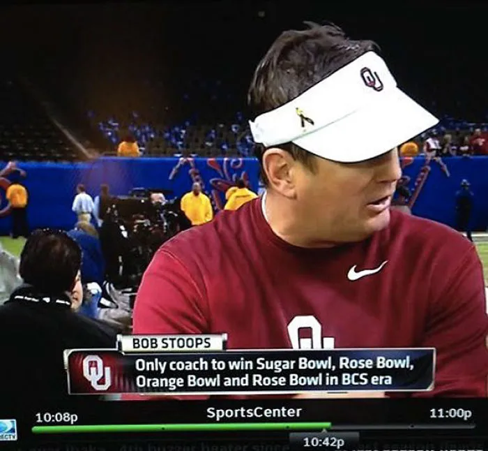 Coach in visor and team shirt on SportsCenter, highlighted for humorous name achievement.