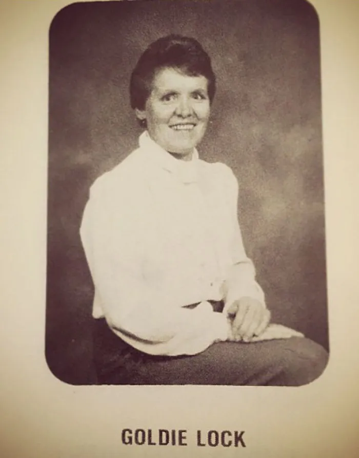 A woman smiling in a vintage portrait with the funny name "Goldie Lock" below.