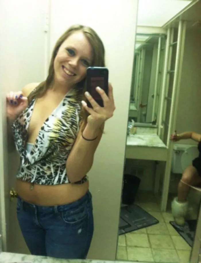 Woman taking mirror selfie 