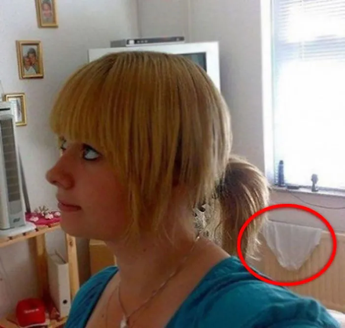 Woman taking selfie with her panties on a background 