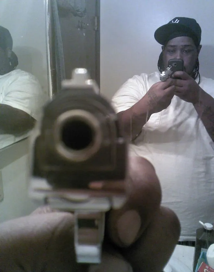 Man taking selfie with the gun