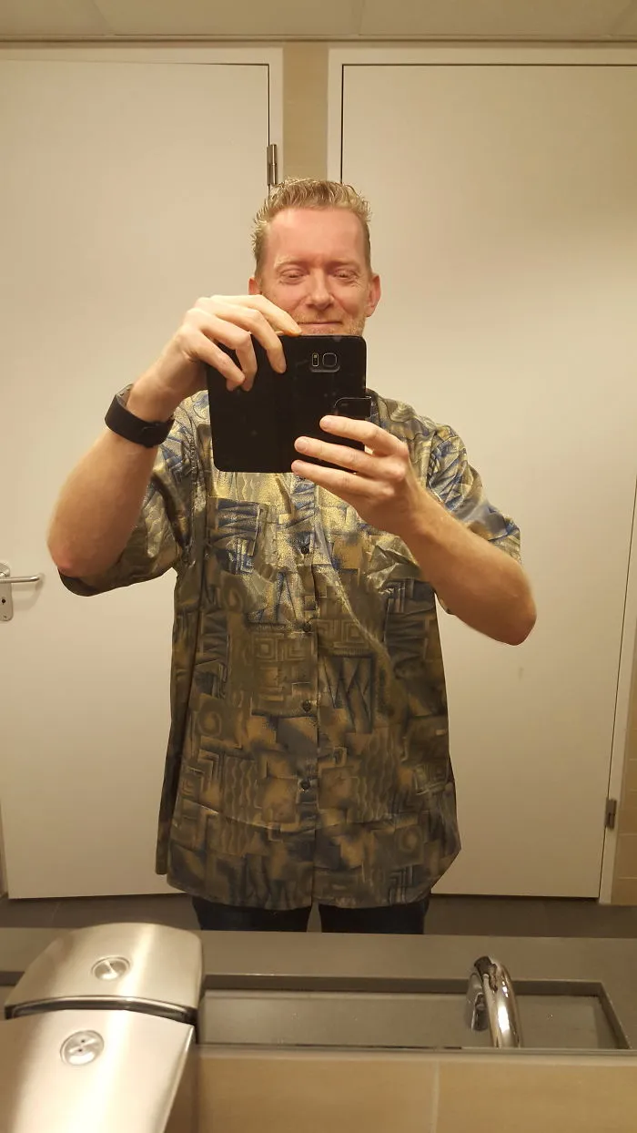 Man taking a mirror selfie indoors, unrelated to people photoshopping Mr. Bean into things hilarious trend.