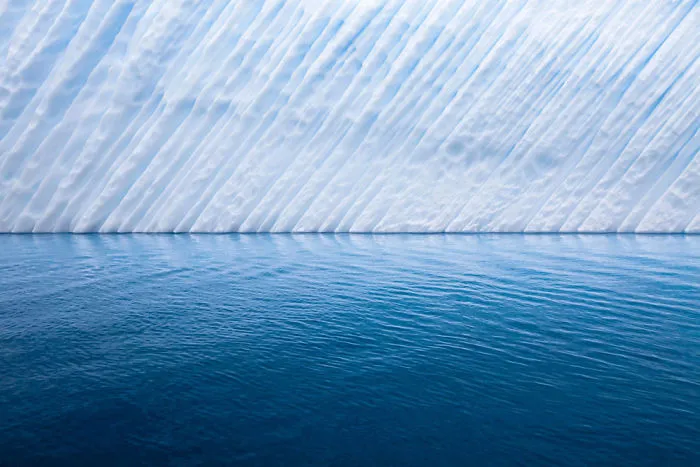 The Edge Of An Iceberg Floating Just Off The Coast Of Antarctica