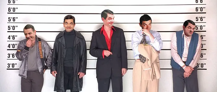 Five men posing in a lineup with photoshopped faces of Mr. Bean in different outfits, creating a hilarious scene.