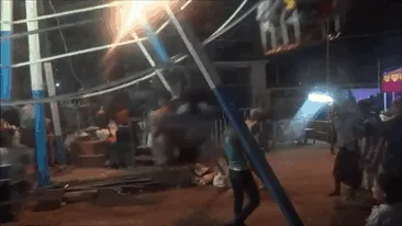 Women live longer; man standing beneath a fast-spinning carnival ride, unaware of its rapidly moving parts.