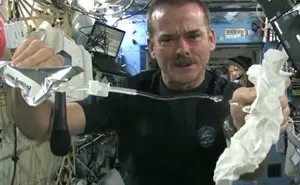 Astronaut Wrings A Wet Towel In Space