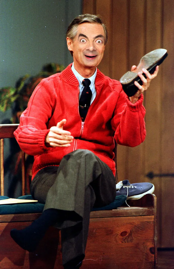 Man photoshopped with Mr. Bean face, wearing red sweater, holding shoe, sitting on wooden bench in an indoor setting.