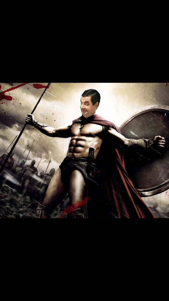 Photoshopped image of Mr Bean with a muscular warrior body holding a spear and shield in a battle scene.