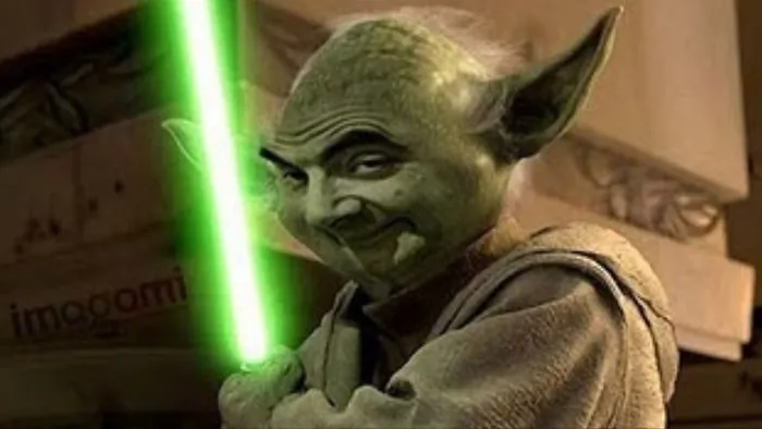 Photoshopped image of Mr. Bean’s face on Yoda holding a green lightsaber, showcasing hilarious edits with Mr. Bean.
