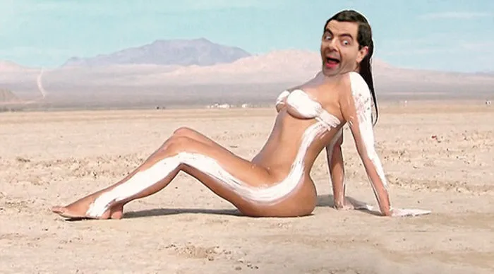 Photoshopped image of Mr. Bean's face on a woman’s body sitting on a sandy desert, showcasing hilarious edits.