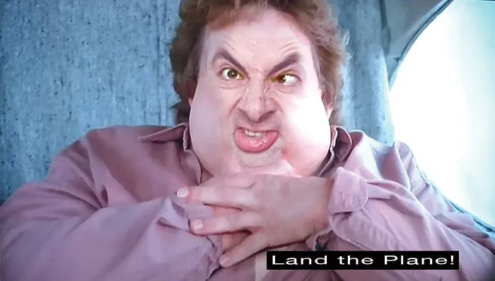 Mr. Bean photoshopped into a plane cabin scene making a funny face with caption Land the Plane for hilarious effect