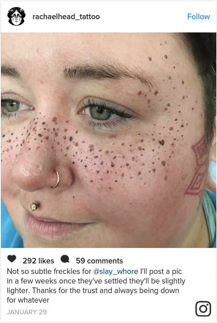Face with tattooed freckles and piercings, showcasing the new beauty trend.