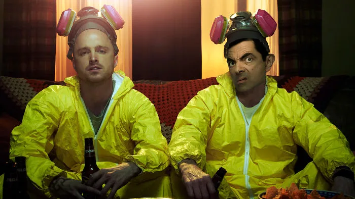 Two men wearing yellow hazmat suits with Mr Bean photoshopped on the right, creating a funny and surreal scene.