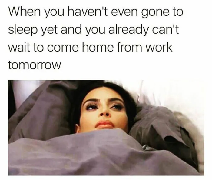 Woman lying awake, thinking about going back to work, illustrating funny work memes.