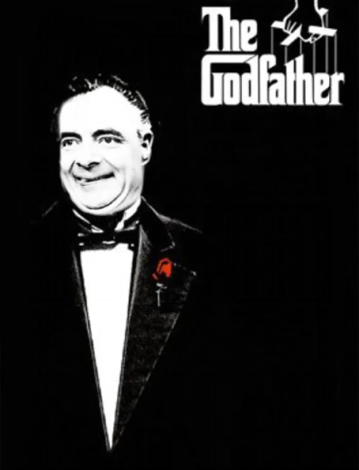 Photoshopped image of Mr. Bean edited into The Godfather movie poster in a tuxedo with a red flower lapel.