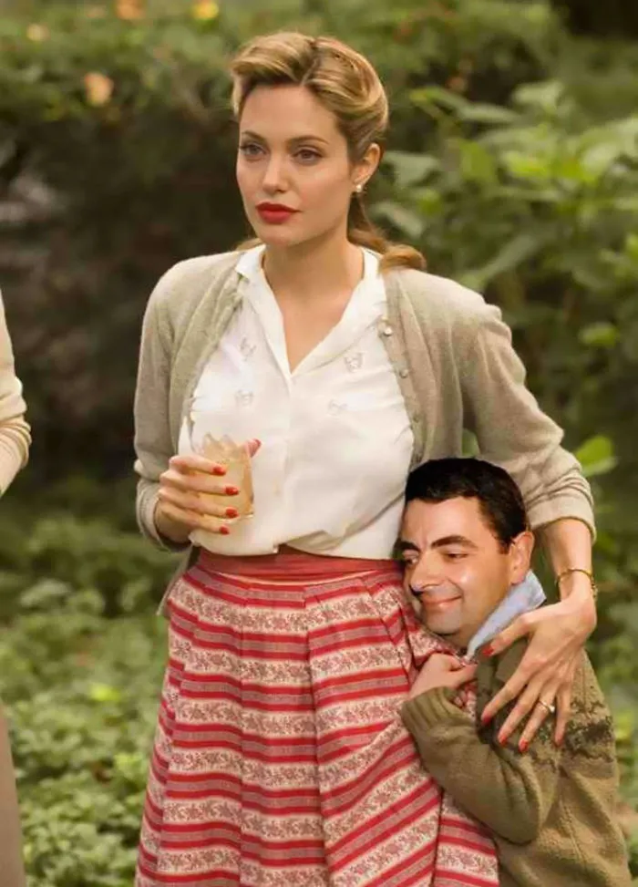 Woman in vintage outfit holding a drink with Mr. Bean photoshopped hugging her, showcasing hilarious Photoshop edits.
