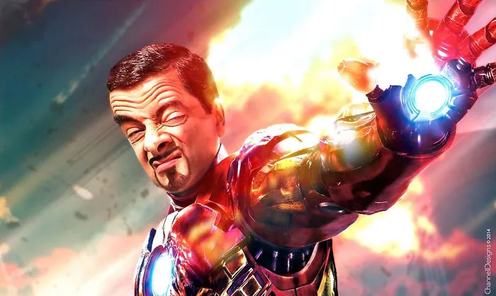 Mr. Bean photoshopped as Iron Man shooting a repulsor beam with an intense expression and fiery background.