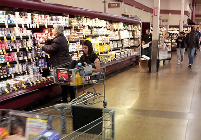 Just A Grown Woman Riding In A Shopping Cart While Her Mother Shops