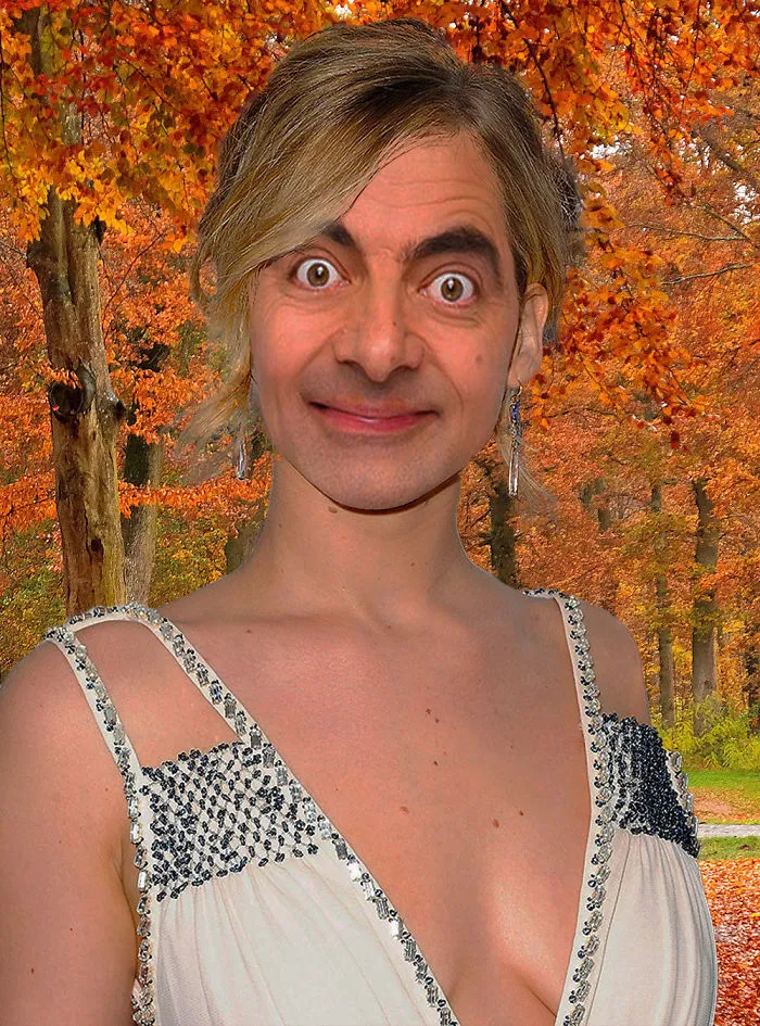 Photoshopped image of Mr. Bean with a glamorous dress in an autumn forest, showcasing hilarious Photoshop creativity.