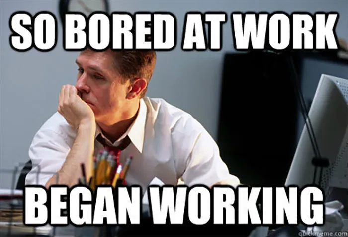 Man at desk looking bored with text overlay: "So bored at work, began working." Funny work meme.