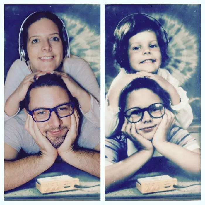 Siblings smiling with headphones recreating a vintage childhood photo with glasses