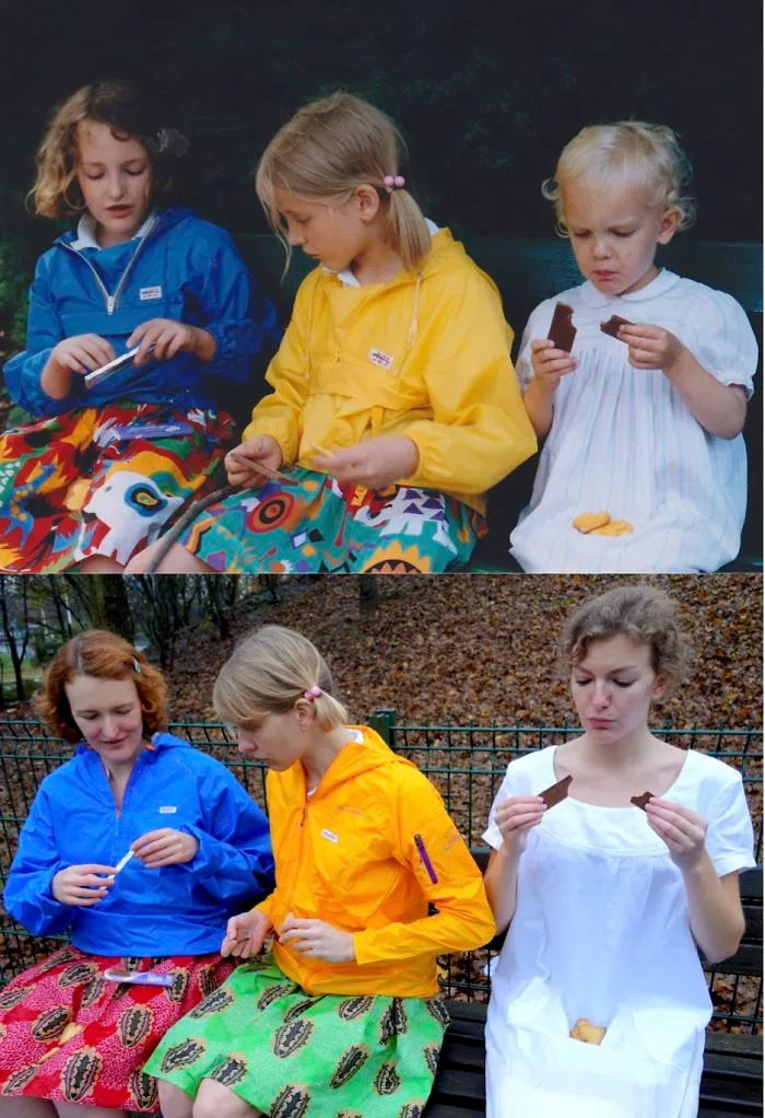 Siblings in colorful jackets and patterned skirts recreating childhood photo outdoors