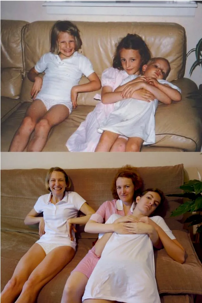 Sisters posing on a couch recreating a vintage sibling photo with pacifier