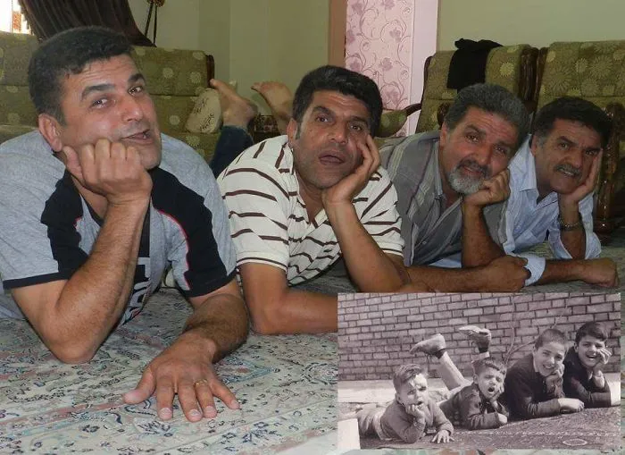 Four adult brothers laying on the floor recreating a childhood photo with similar poses