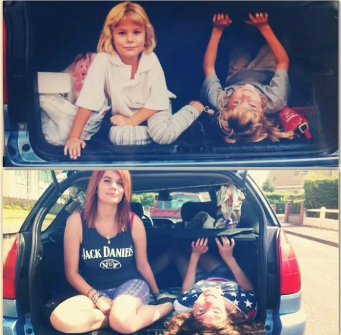 Siblings sitting in car trunk recreating a childhood photo