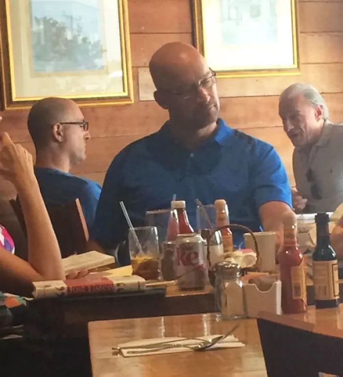 Person sitting and wearing blue shirts and looking similar