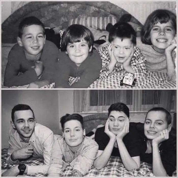 Four siblings recreate childhood photo lying on bed and smiling in black and white