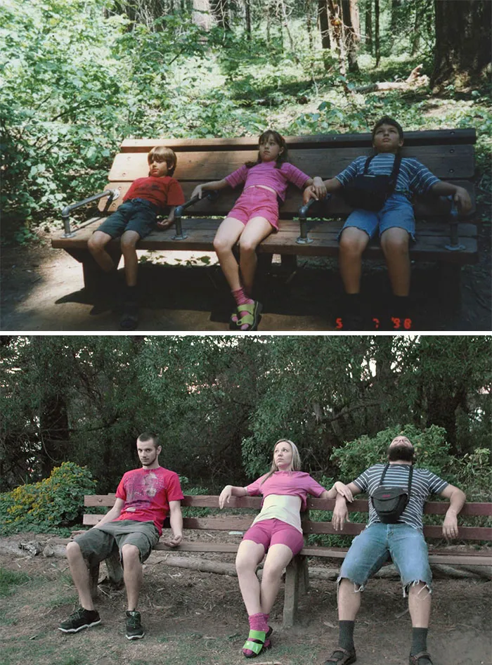 Siblings recreating childhood photo while sitting on a bench in forest