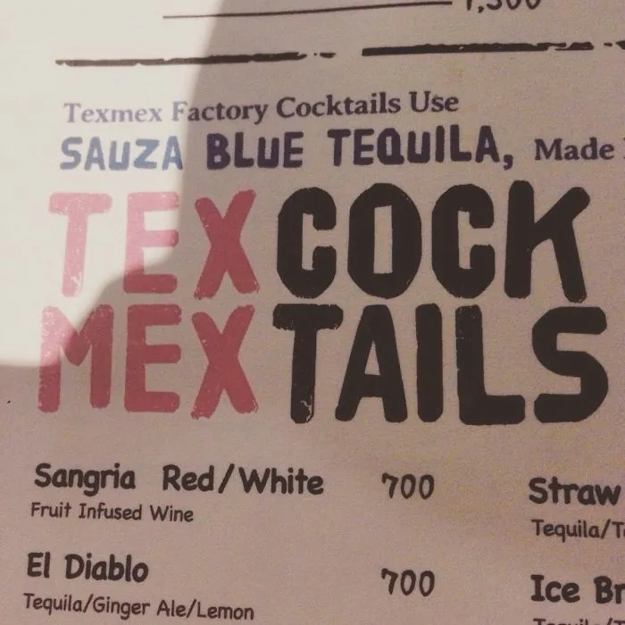 Menu design fail featuring amusing spacing error in "Tex Mex Cocktails" text.