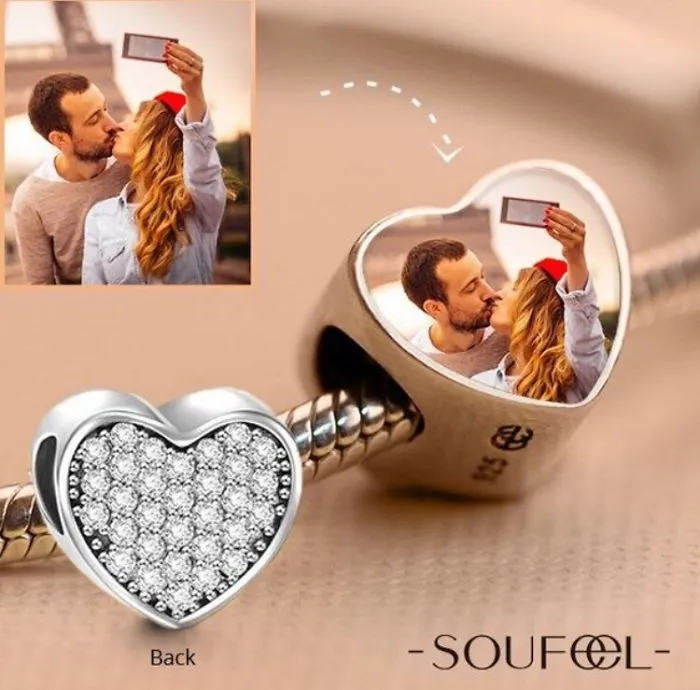 Heart-shaped charm reflecting a couple's selfie, highlighting funniest design fails with unexpected photo placement.