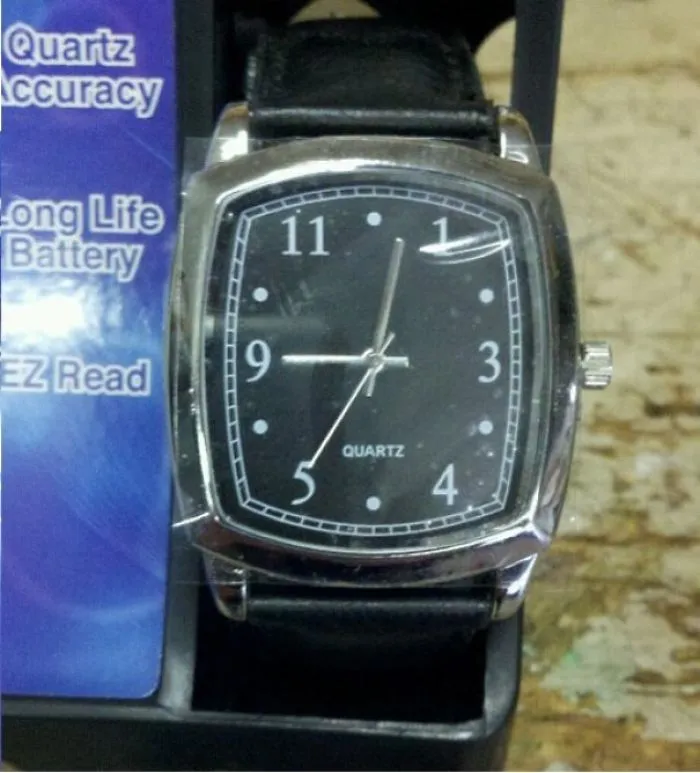 Watch with mismatched time markings, labeled as "Quartz Accuracy," showcasing a design fail.