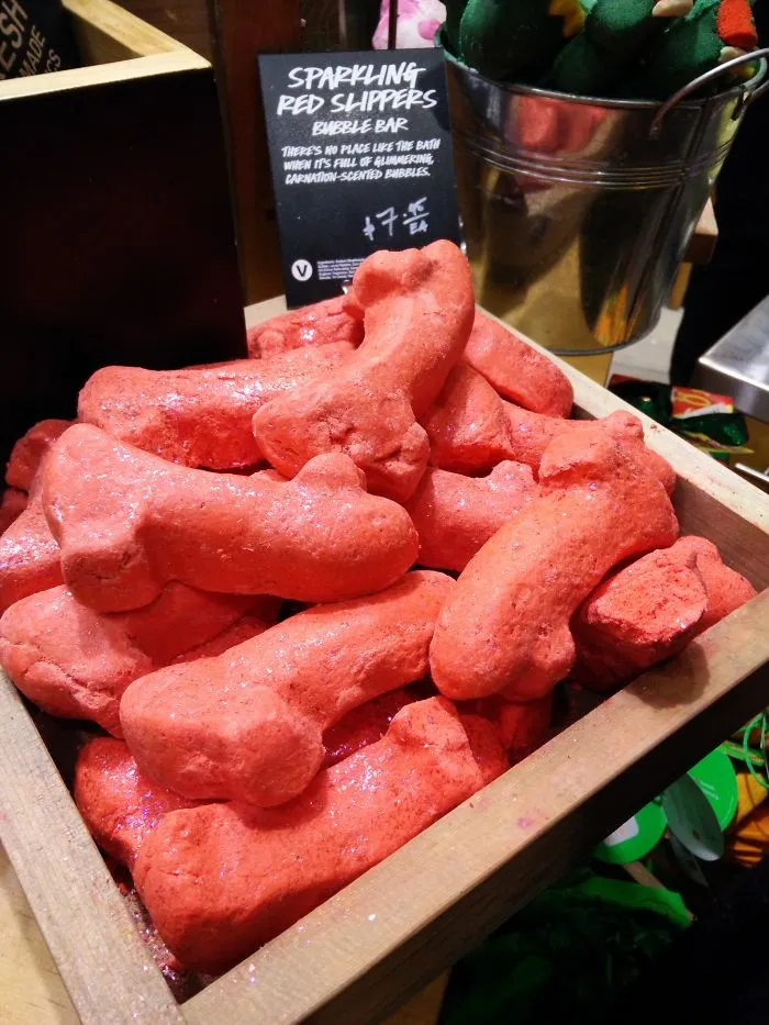Sparkling red bubble bars in a display case, showcasing a quirky design fail.