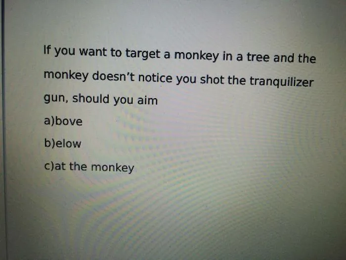 Multiple choice question with a funny design fail about aiming at a monkey with a tranquilizer gun.