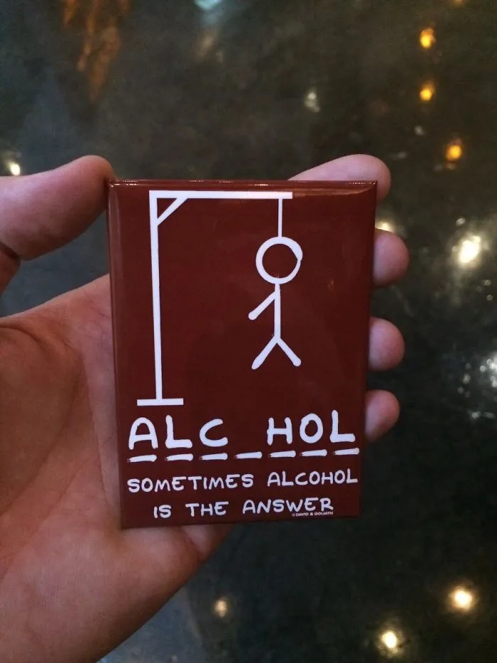 Design fail showing a hangman game with "ALC_HOL" and the phrase "Sometimes alcohol is the answer" below it.