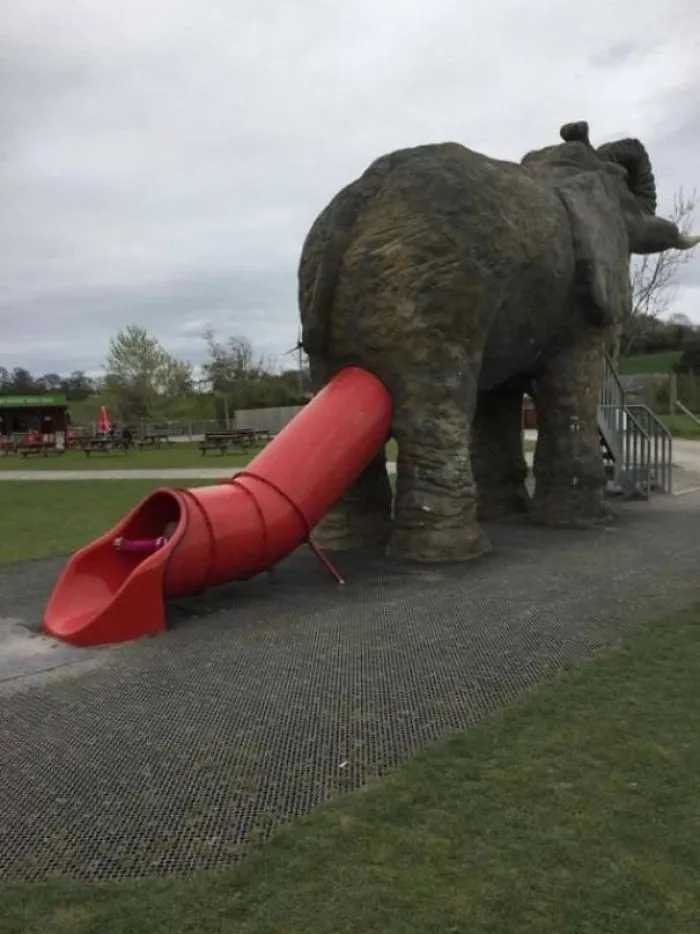 Elephant-shaped playground slide with the exit awkwardly positioned at the rear, showcasing a design fail.
