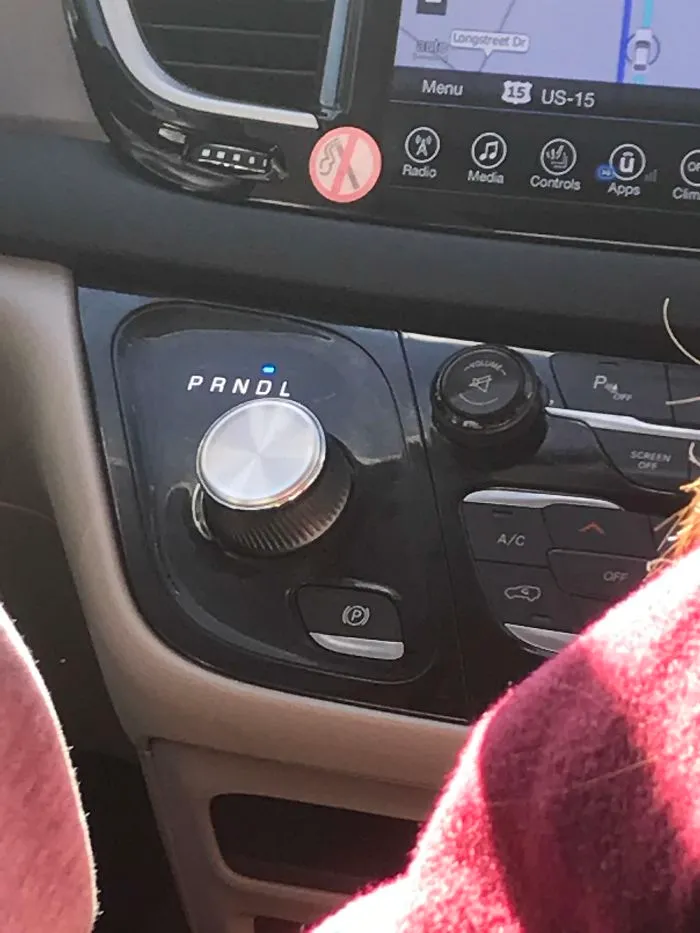 Car dashboard design fail with incorrect gear label marked "PRNDL."
