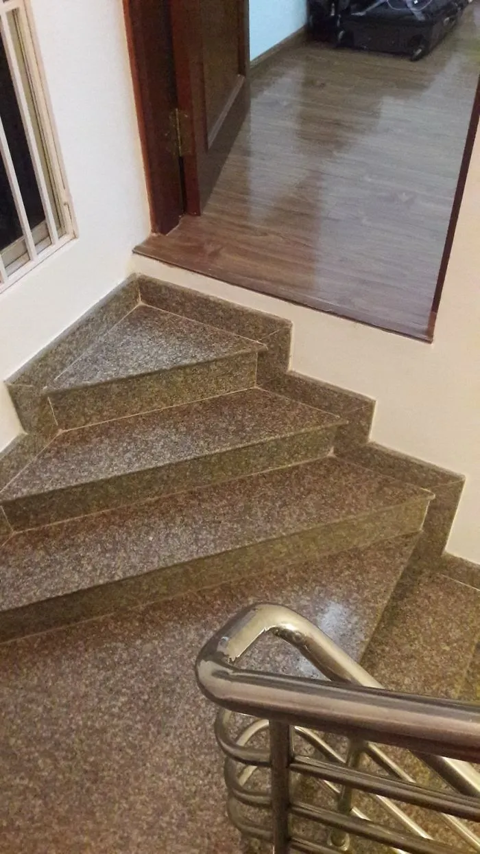 Staircase leading directly into a closed door, showcasing a funny design fail.