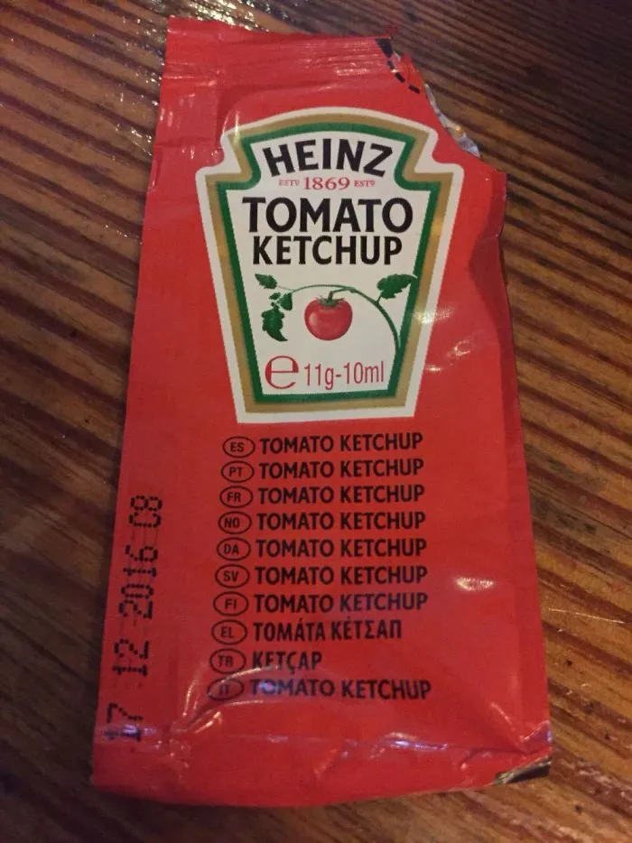 Heinz ketchup packet with "Tomato Ketchup" listed in multiple languages; an example of funniest design fails.