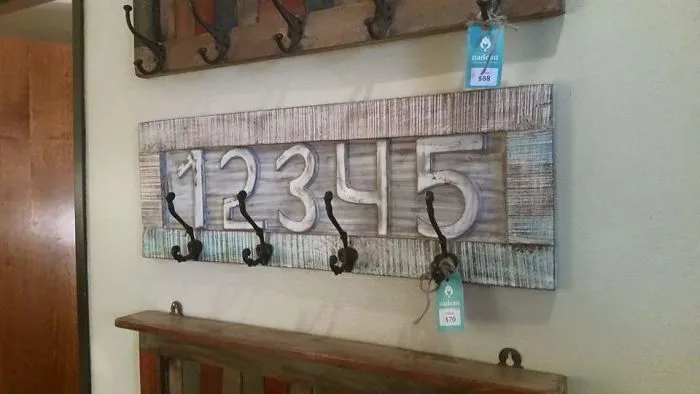 Coat hooks misaligned under numbers, illustrating a funniest design fail.