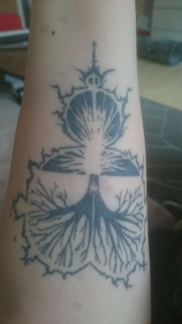 Intricate tattoo art on arm creatively transforms scar into detailed, artistic design.