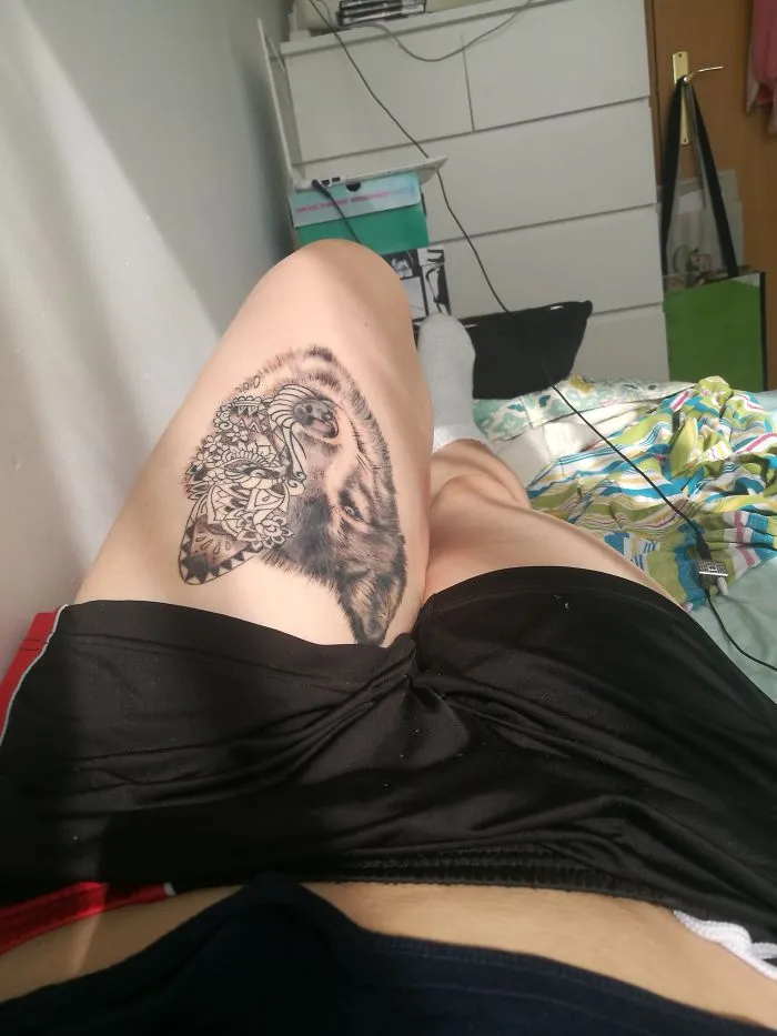 Tattoo art on thigh creatively incorporates a scar, transforming it into a detailed design.