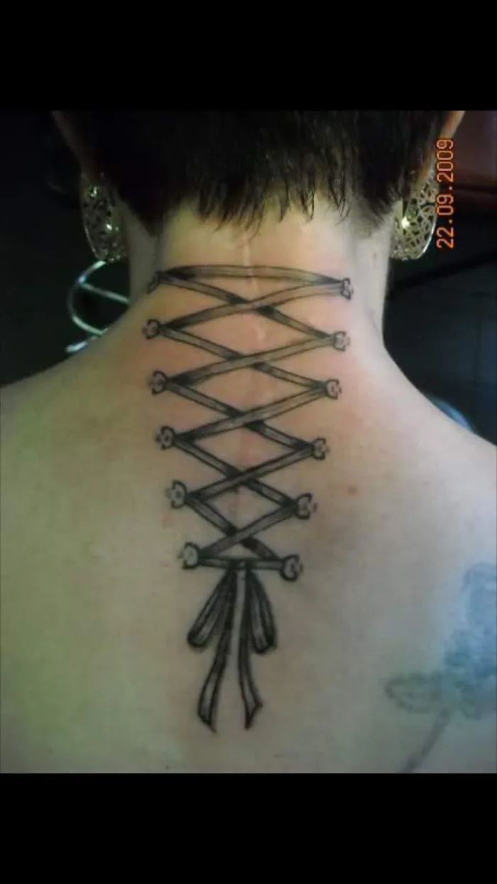 Tattoo art transforming a scar on the neck into a laced ribbon design.